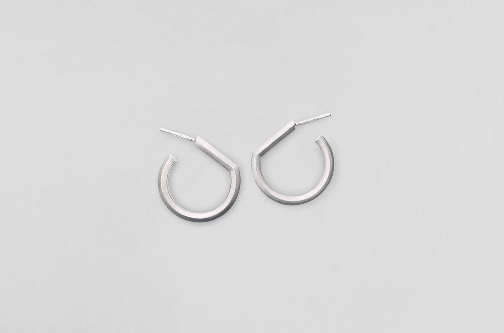A handcrafted sterling silver earring from Arch collection by Makiami. Every piece is handcrafted by us, in our metalsmithing workshop in Stockholm, Sweden.
