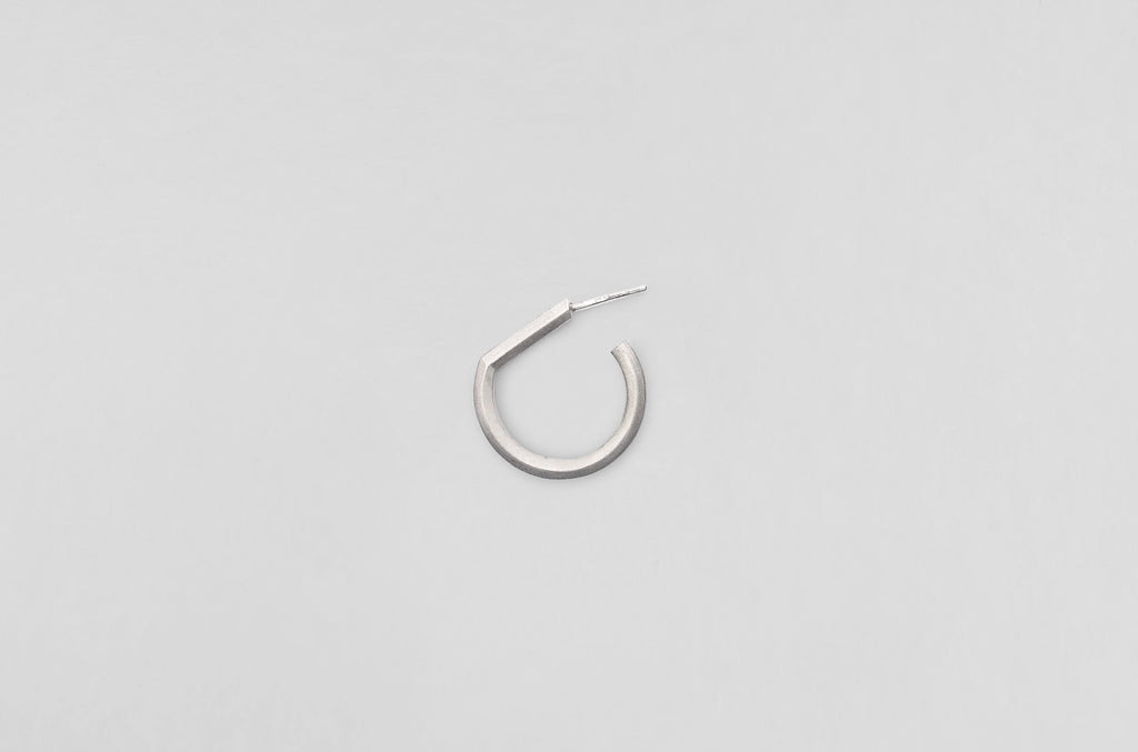 A handcrafted sterling silver earring from Arch collection by Makiami. Every piece is handcrafted by us, in our metalsmithing workshop in Stockholm, Sweden