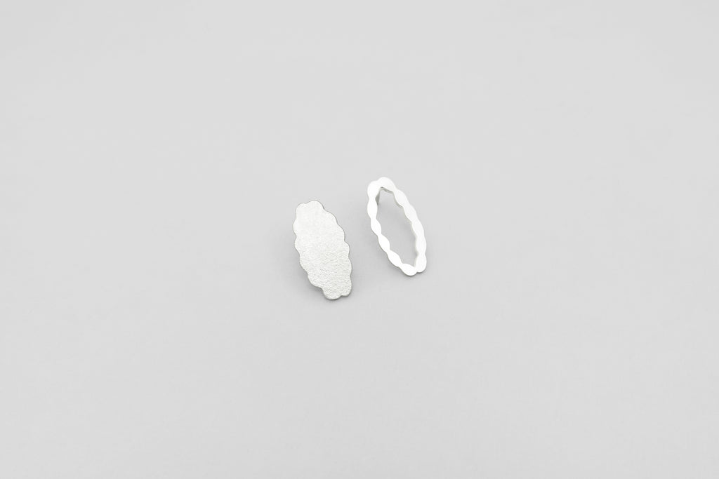 A handcrafted silver earring from Paper Shadow collection by Makiami. Every piece is handcrafted by us, in our workshop in Stockholm.